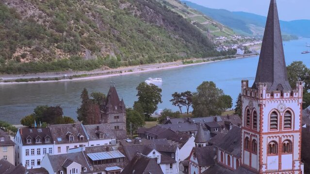 Grape Escape Rhine Valley, medieval German Bacharach city, Old Post Compound With Postenturm, wide waters of Rhine River, slate roofs of old half-timbered houses, wine tourism in Rhineland-Palatinate