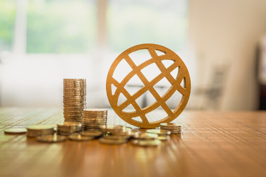 Coins stack and Globe model on wood table, concepts for systems of raising or lowering, World Interest Rates ,Fed interest rates to correct inflation concepts.	