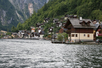 Fototapeta premium A lakeside town with colorful buildings and boats on the water, Austria