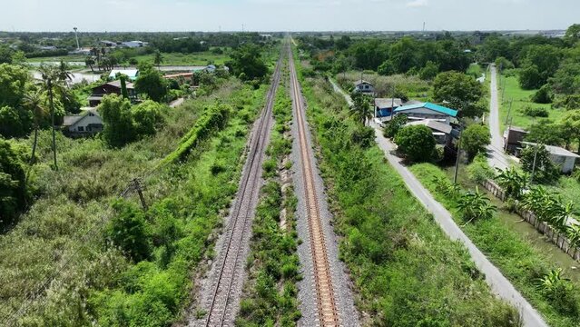 sky view above contry side small town with green field and rail road