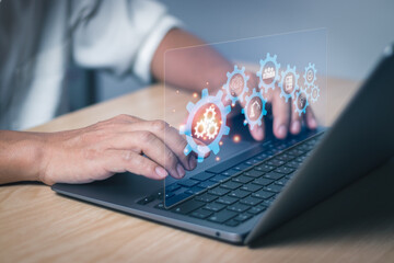 businessman hand typing on keyboard with gear icon Show software automation workflow,Concept Robotic process automation and business process management