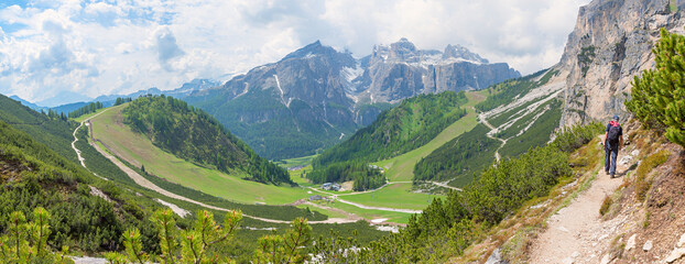 man at idyllic hiking trail Col Pradat, Colfosco, dolomites landscape Alta Badia south-tyrol