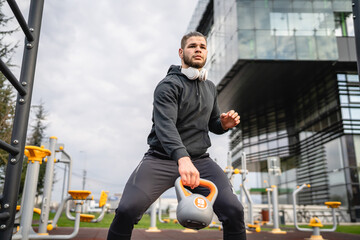 One man young adult caucasian male train with kettlebell girya weight