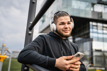 One man caucasian young male stand at outdoor open training park gym