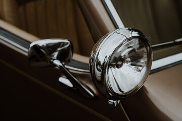 Vintage old brown car headlight detail. Retro car lamp.	