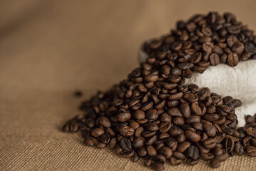 Roasted coffee beans on hemp background.