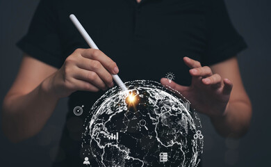 Hand holding a pen pointing at the globe picture. The concept of searching for information needs through internet technology. Targeting for Online Marketing