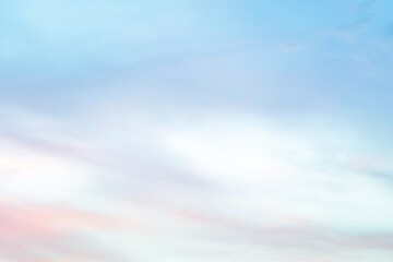 Twilight sky with effect of light in pastel pink, coral, orange, blue tones. Colorful sunset of soft clouds. Background