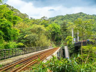 Shifen water park with railway track in natural environment, landmark near Taipei in Taiwan, summer season