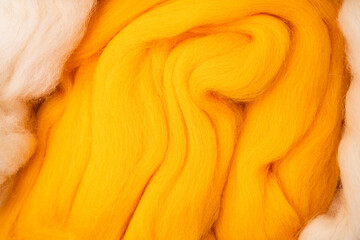 White, yellow-orange merino wool for felting.