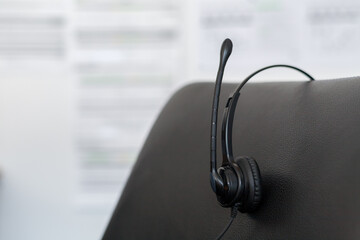 The headset of a customer support employee, left behind after artificial intelligence takes over his job 