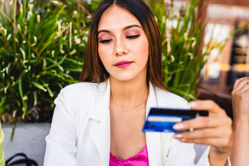 Close up view of a woman holding a credit card.