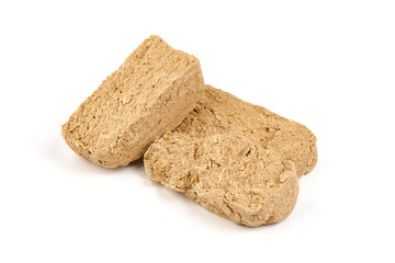 Pieces of sunflower halva, isolated on white background.