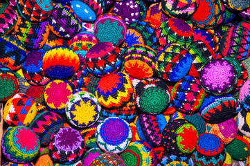 Colorful textile for sale in public space in Guatemala City, work done by indigenous hands of millenary Mayan culture, handicraft work economy in Latin America. - 620625599
