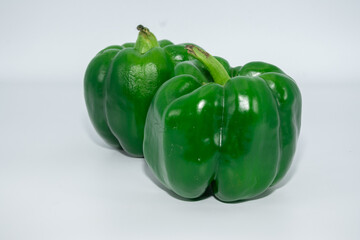 Fresh green pepper photographed from the front on a white background