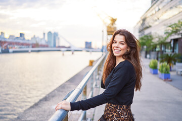 Fototapeta premium portrait beautiful latin american woman looking and smiling happy in exterior of Puerto Madero