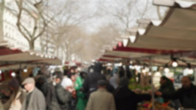 shoppers walking through fresh market in Paris