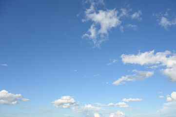 Naklejka na ściany i meble Bright sky with white clouds with blue sky background.