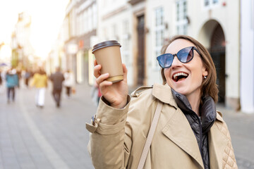 Portrait young beautiful happy smiling woman drinking coffee to go tea in eco sustainable paper cup...
