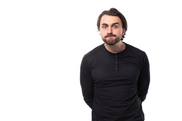 close-up portrait of a young 30 year old doubting bearded well-groomed brunette with a chic stylish hairstyle