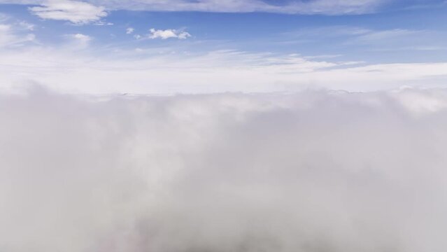 View from the side window of the plane to the clouds. Flight during the day through the clouds. aerial view