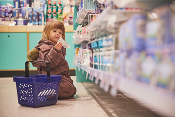 charming child shopping in a supermarket in Denmark