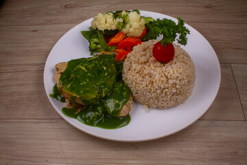 Cilantro chicken With Grilled Veggies in white plate on wooden background