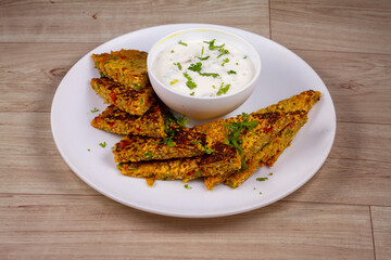 Oats Cheela in white plate on wooden background