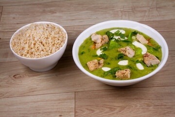 Chicken Keto Thai Green Curry in white bowl on wooden background