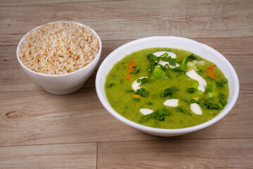 veg Keto Thai Green Curry in white bowl on wooden background
