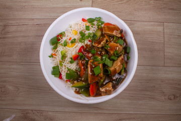 Chicken Pot Rice in white plate on wooden background