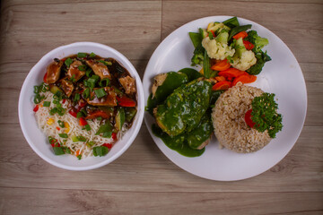Chicken Pot Rice and Cilantro chicken With Grilled Veggies in white plate on wooden background