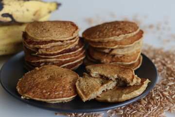 Fototapeta na wymiar Khapli wheat plantain pancake. A healthy version of pancakes made of emmer wheat flour, ripe plantain, sweetened with jaggery