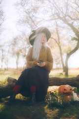 Girl dressed as a witch and Jack-o-lantern