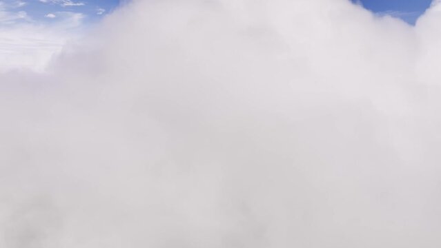 View from the side window of the plane to the clouds. Flight during the day through the clouds. aerial view