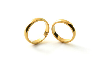 Engagement gold rings standing next to each other white background