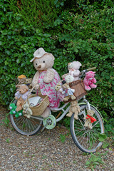 A Group of 14 Teddy Bears on an Old Bicycle