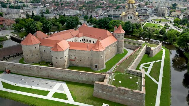 Aerial perspective of Fagaras City. Drone descending close to Făgăraș Citadel.  Beautiful panoramic view of all city of Fagaras. The fortress was a prison for political detainees. Today is an museum