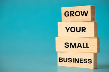 Grow Your Small Business, Written on Wooden Boards, Business Concept, Small Business Support, Copy Space, blue Background