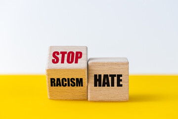 wooden blocks that change the phrase Racism Hate into the slogan stop hate, Beautiful yellow and...