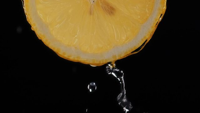 Juicy lemon. Fresh lemon Slice. Squeeze out juice. Water dripping on a lemon slice.