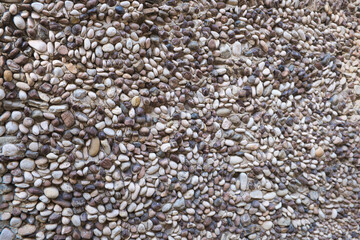 view of a section of a pebble wall, ancient greek technique, in taormina, sicily, italy