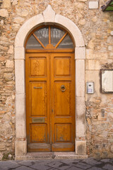 Fototapeta na wymiar old wooden front door in Taormina, Sicily, Italy