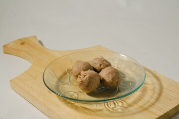 Four meatballs served on a small plate