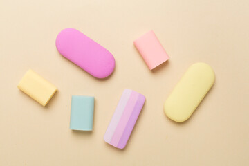 Colorful eraser on color backgroung, top view