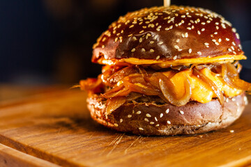 Delicious Burger with Melted Cheddar and Caramelized Onions on Australian Bun