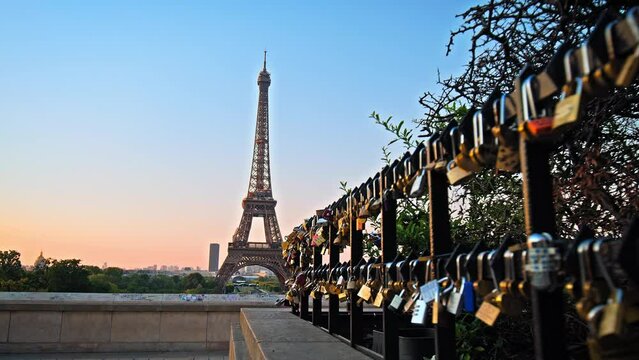 The Story of Love locked in front of the historical landmark in Paris. Visitors attach personalized padlocks to the railing, romantic tourists promising love to each other in Paris, France.