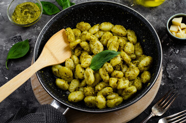 Gnocchi with Pesto, Potato Gnocchi Tossed with Basil Pesto Sauce, Italian Cuisine, Tasty Meal over Dark Background