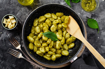 Gnocchi with Pesto, Potato Gnocchi Tossed with Basil Pesto Sauce, Italian Cuisine, Tasty Meal over Dark Background