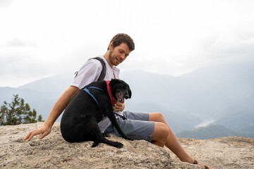 Man and dog at viewpoint nature